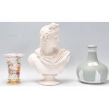 A 20th Century ceramic bisque bust depicting the Greek God Apollo together with a Wedgwood