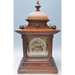 Junghans - A good 19th Century Victorian oak cased mantel clock having a decorative carved case with