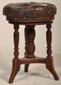 A Victorian 19th century mahogany and leather revolving piano stool. Raised on ring turned legs with