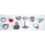 A group of ten silver rings to include a ring set with a faceted brown stone, a heart design ring