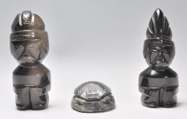 A vintage 20th Century pair of polished carved stone tribal fertility figures together with a carved
