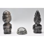 A vintage 20th Century pair of polished carved stone tribal fertility figures together with a carved