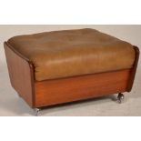 A retro teak wood 20th century G-Plan upholstered footstool ottoman. Raised on castors with teak