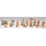 A collection of Goebel Hummel figurines to include sixteen figures all marked Goebel to the bases.