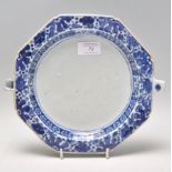 A 18th century Chinese blue and white plate warmer of octagonal form having hand painted