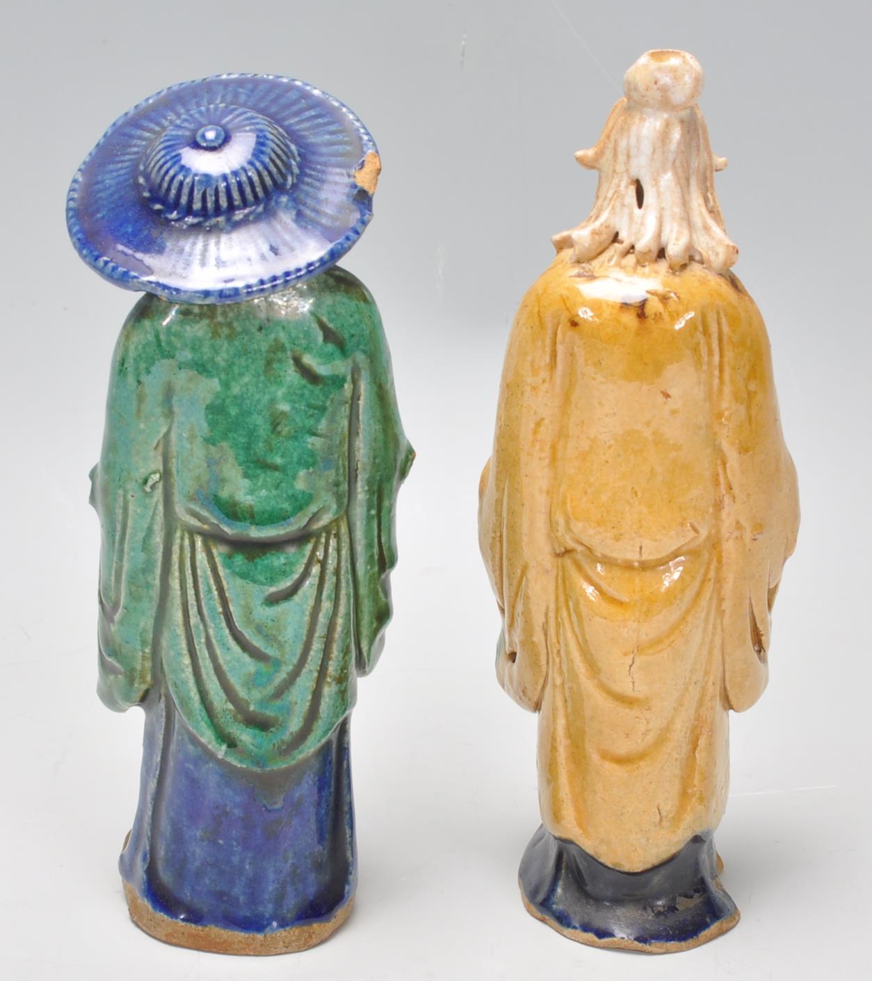 A pair of 1920's Chinese export Ming Dynasty style ceramic figurines in the form of two men glazed - Image 3 of 7