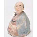 A late 18th / early 19th Century Japanese Meiji period stoneware nodding figurine in the form of a