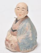 A late 18th / early 19th Century Japanese Meiji period stoneware nodding figurine in the form of a