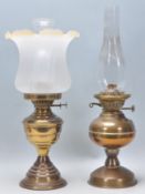 Two 19th Century Victorian oil lamps one having a stepped base with a fanned glass shade, the the of