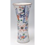 A 19th Century Chinese vase having a flared rim and banded center decorated with village scenes with