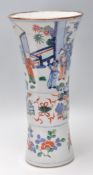 A 19th Century Chinese vase having a flared rim and banded center decorated with village scenes with