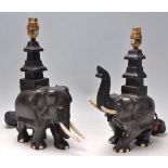 A pair of vintage 20th Century ebonised carved elephant table lamps with bone tusks and feet.