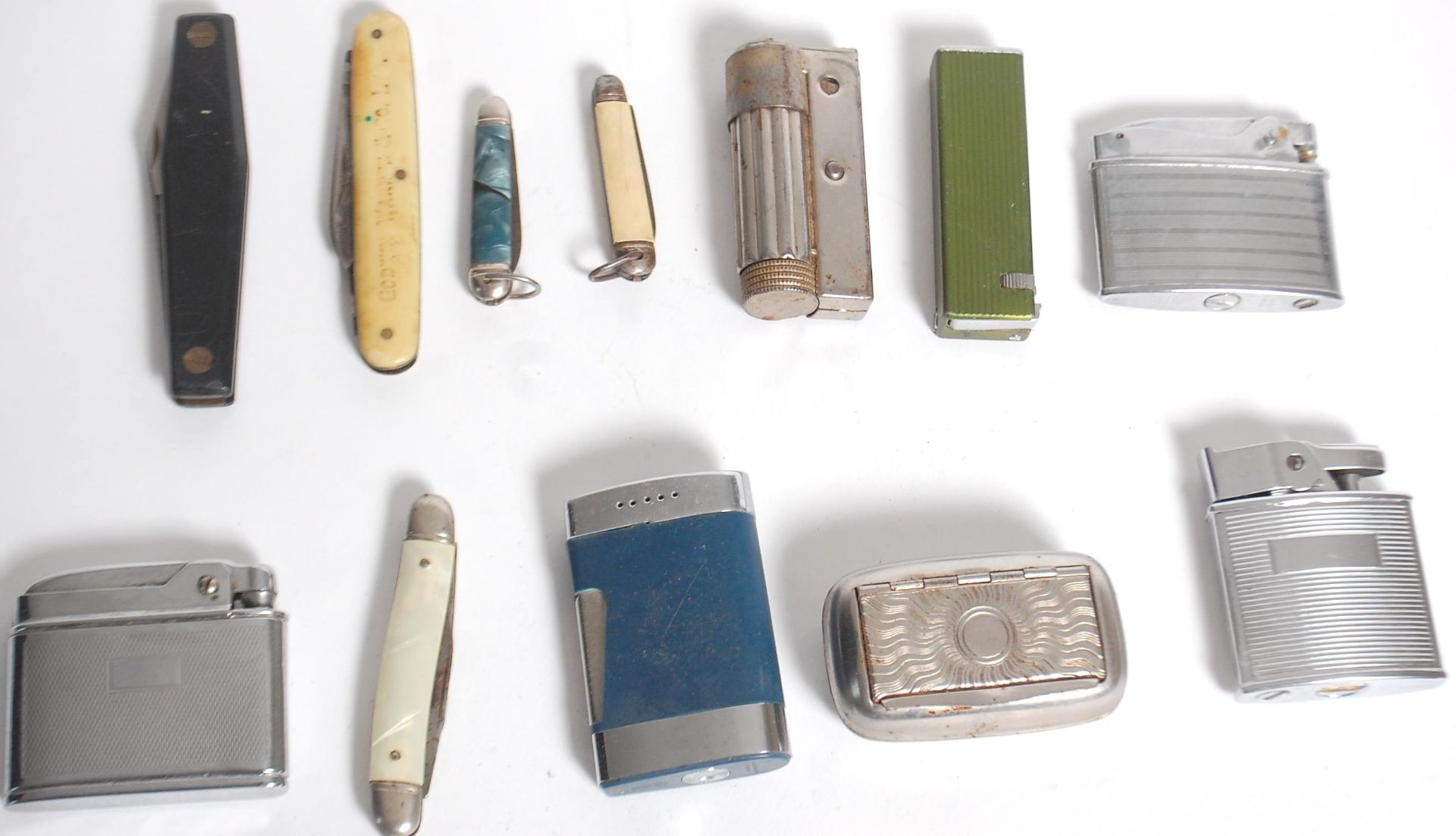 A small group of vintage lighters and penknives to include a Penguin Superlative automatic