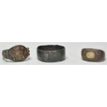 A collection of 3 Roman rings to include a bronze band ring, copper hammered ring with partial