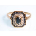 An Art Deco style ladies 9ct yellow gold ring set with a central oval blue cut stone having an