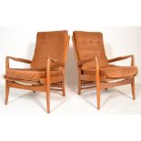 A pair of mid century teak wood Cintique armchairs