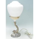 A vintage retro Art Deco table lamp having a round stepped design shade with Maltese dolphin