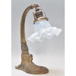 An early 20th Century Art Nouveau brass table / desk lamp having an opaline glass handkerchief