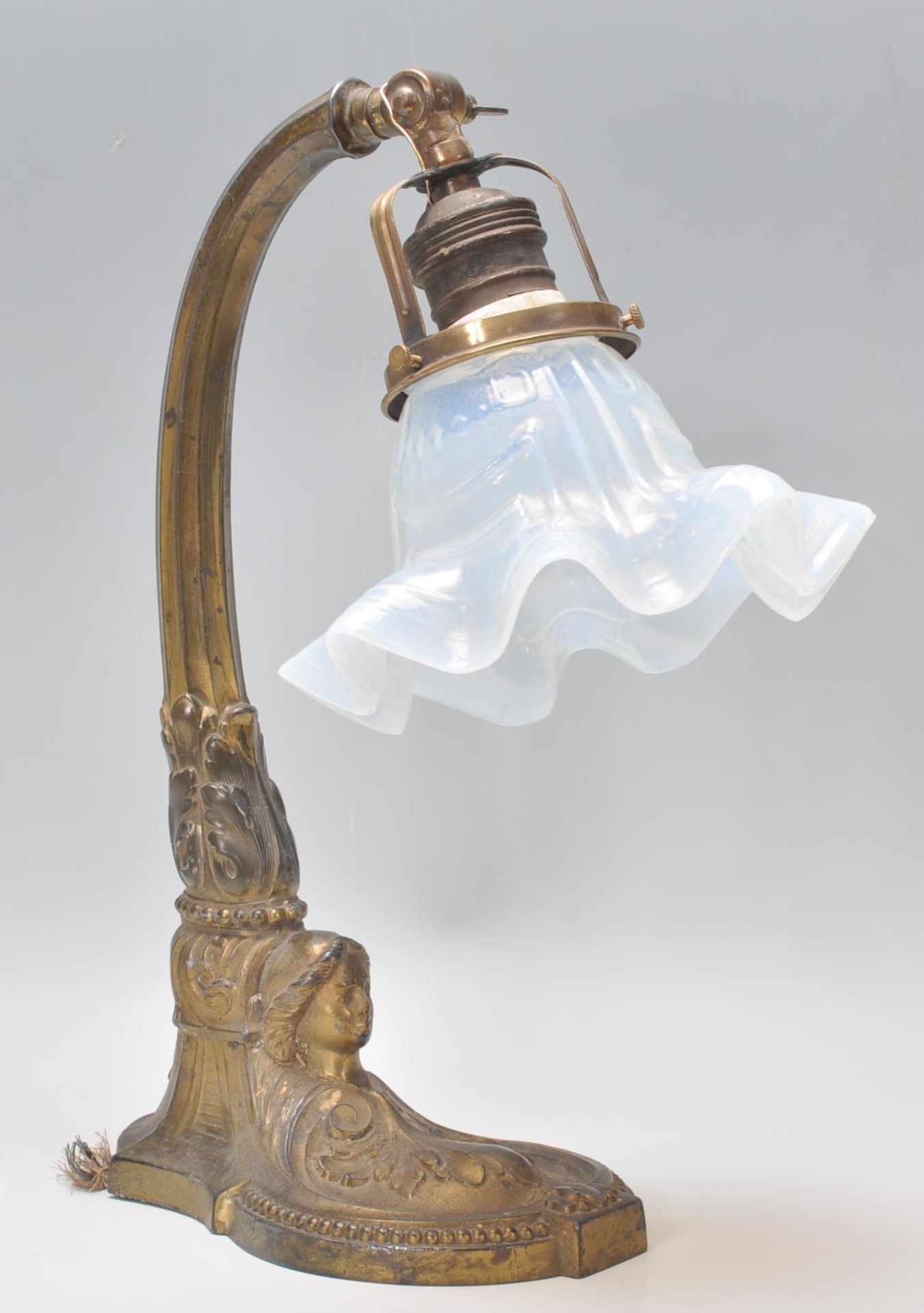 An early 20th Century Art Nouveau brass table / desk lamp having an opaline glass handkerchief