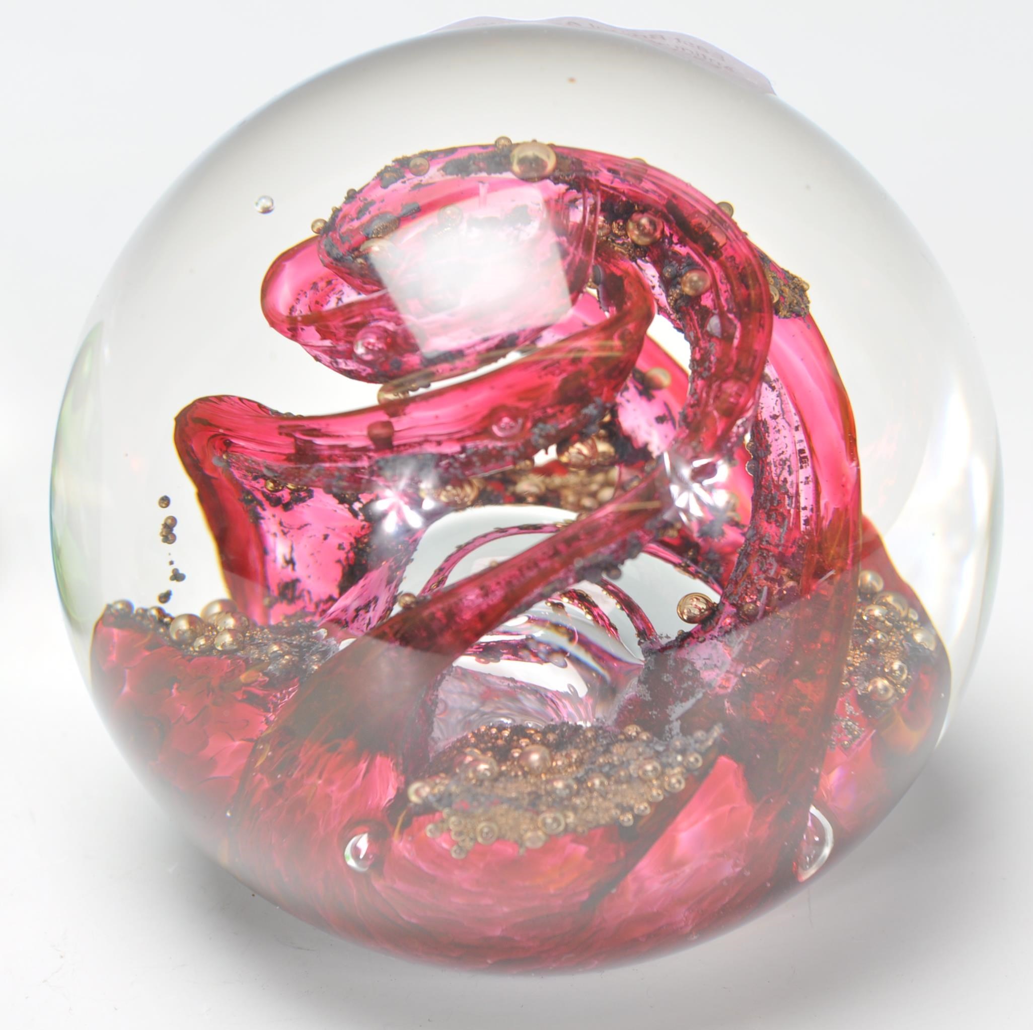 A group of four paper weights to include a Selkirk Scottish paper weight of red swirl design (signed - Image 3 of 7