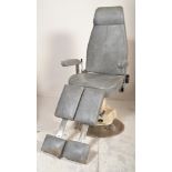 A retro 20th century Industrial - medical industry dentists / theatre chair being upholstered in