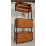 A mid century teak wood modular single bay Avalon system. The metal uprights supporting a bank of