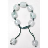 A vintage 20th Century Chinese green jade bangle bracelet having seven large round jade beads with