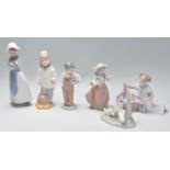 A group of Nao ceramic figurines to include a boy holding a football, a group of ducks, a lady