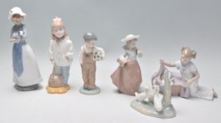 A group of Nao ceramic figurines to include a boy holding a football, a group of ducks, a lady