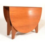 A 1970's retro teak wood drop leaf dining table be