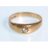 A hallmarked 9ct yellow gold ladies single stone diamond ring in a gypsy style setting. Diamond of