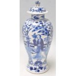 A 19th Century Chinese porcelain lidded baluster vase being painted with blue and white having a