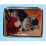 A stamped sterling silver pill box of square form having an enamelled lid with a kitten and wool