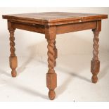 A good early 20th century oak  small proportioned barley twist fold out leaf  / draw dining table
