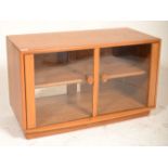 A good Ercol TV display unit stand of rectangular form having twin glazed doors with shaped wooden