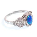 A stamped 925 silver ring having a central opal panel and CZ accent stones. Weight 3.3g. Size N.5.