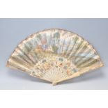 A 19th Century Victorian ivory and paper fan having a hand painted classical river scene to the