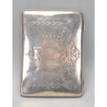 An early 20th Century silver hallmarked cigarette case having finley engraved floral and ribbon