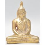A Tibetan bronze figure of Bodhisattva Buddha seated in the lotus position wearing robes with carved