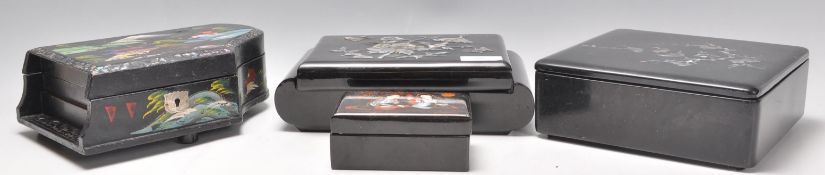 A group of four vintage 20th Century Japanese black lacquer jewellery boxes to include a musical