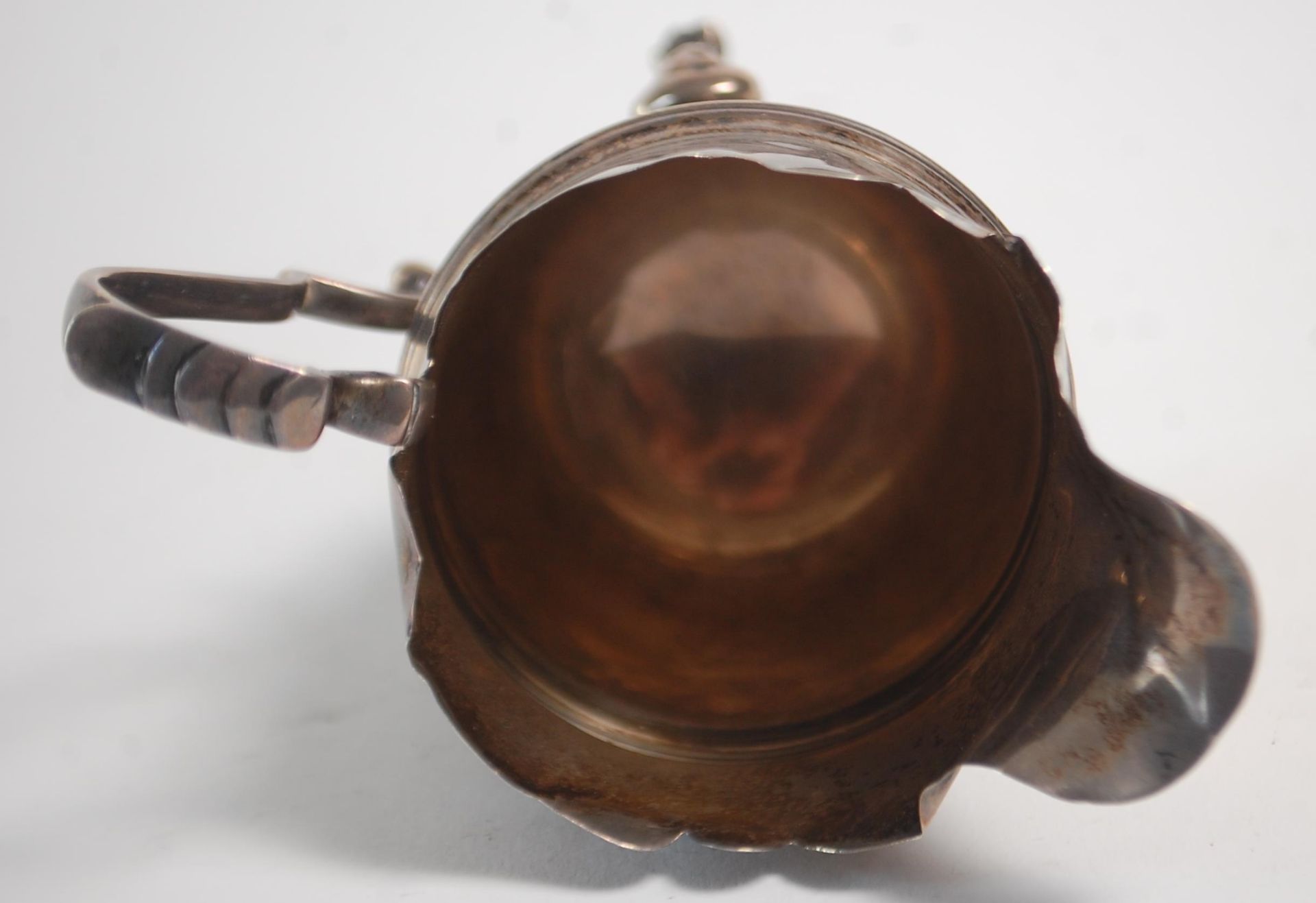 An early 20th Century silver hallmarked creamer jug having a flared top with banded center raised on - Image 8 of 9