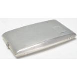 A silver hallmarked cigarette case of rectangular shape having engine turned decoration with
