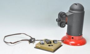 A vintage 20th Century Mickey Mouse 'Ateuers Mundus' French film lantern projector raised on a red