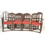 A set of 8 Ercol gothic revival early 20th century dining chairs. Raised on squared legs united by