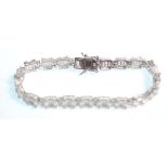 A stamped 925 silver tennis bracelet set with square and round cut CZ's. Measures 7 inches. Weight