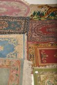 A collection of Persian and Islamic rugs from the 20th century to include oval red medallion, blue