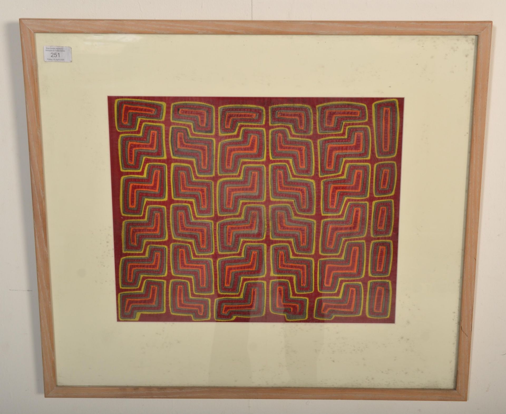 A 20th Century Panamanian mola cloth having a hand stitched applique stylised geometric design