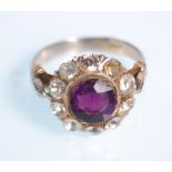 WITHDRAWN - A 14ct white gold amethyst and diamond cluster ring. The round facet cut amethyst within