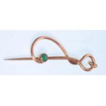 An early 20th Century Art Nouveau Murrle Bennett & Co gold pin of knot design set with a turquoise