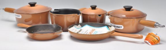 Le Creuset - A set of five graduating cast iron French saucepans and lids ( one lid missing ),
